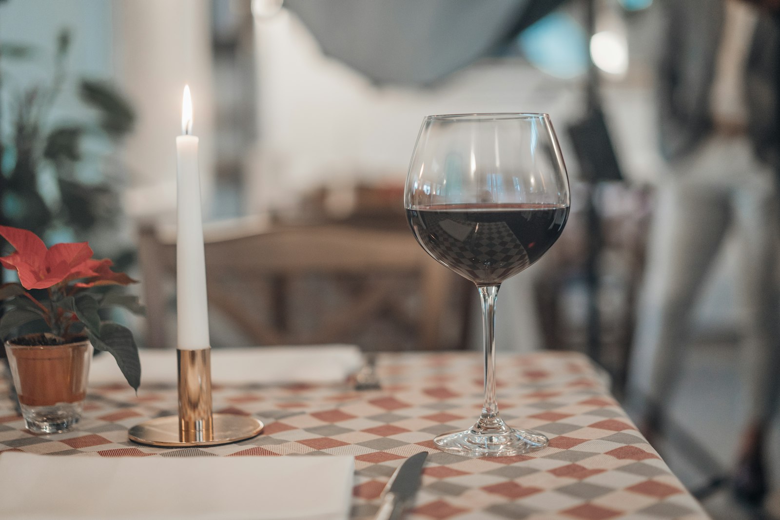 A slow Healdsburg dinner — pasta plate, wine glass, candlelight, two seats pulled close